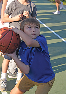 young boy about to throw a basketball